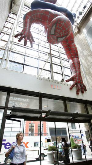 
A woman enters the atrium at Sony headquarters under a giant Spiderman in New York on Monday. New York State Attorney General Eliot Spitzer announced an agreement to halt "pay-for-play" in the music industry. 
 (Associated Press / The Spokesman-Review)