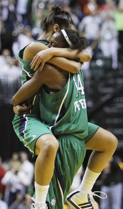 Notre Dame’s Devereaux Peters, right, and Skylar Diggins share a victory hug. (Associated Press)