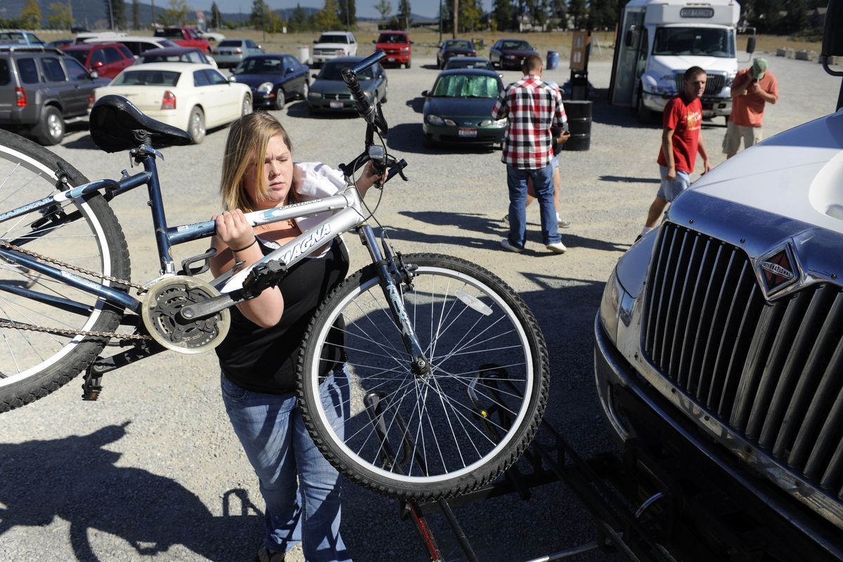 Ashlee Littell, a frequent rider of the Citylink service, loads her bike on the front of a bus Friday at the Riverstone transfer station in Coeur d’Alene. The system is funded by the federal government, the Coeur d’Alene Tribe, Kootenai County cities and Kootenai Medical Center. (Jesse Tinsley / The Spokesman-Review)