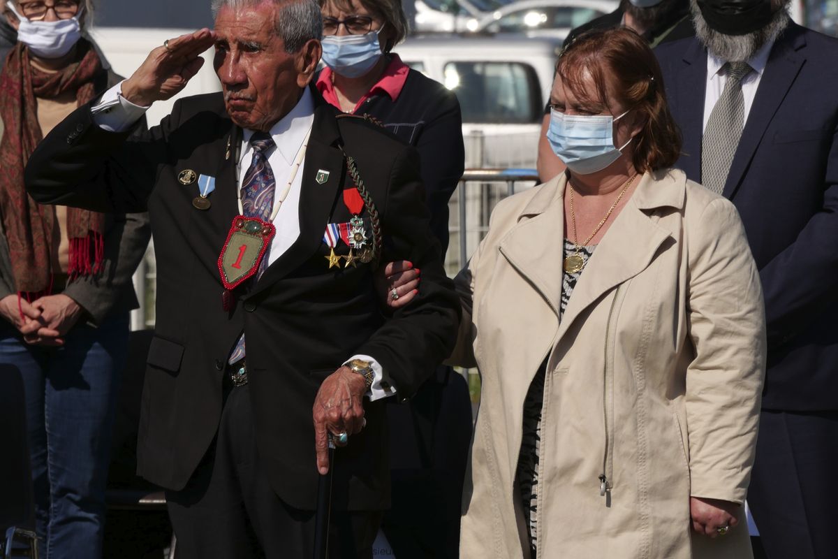 Charles Shay, a 96-year-old Native American from Indian Island, Maine, salutes during a D-Day ceremony Friday in Carentan, Normandy. Shay was a 19-year-old U.S. Army medic when he landed on Omaha Beach. (Nicolas Garriga)