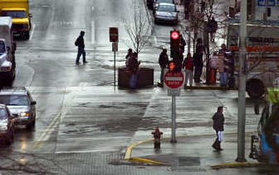 
Traffic, weather and pedestrians mix Thursday in downtown Spokane  in this view looking south across Riverside Avenue on Wall Street. 
 (CHRISTOPHER ANDERSON / The Spokesman-Review)