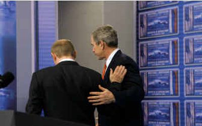 
Arm-in-arm as they wrap up a day of meetings, President Bush and Russia's President Vladimir Putin depart a news conference Thursday in Bratislava, Slovakia.
 (Associated Press / The Spokesman-Review)