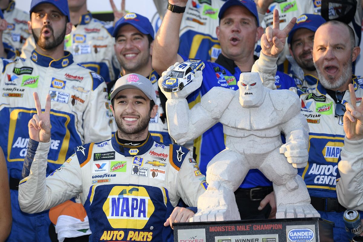Chase Elliott, front left, poses with the trophy in Victory Lane after he won a NASCAR Cup Series auto race, Sunday, Oct. 7, 2018, at Dover International Speedway in Dover, Del. (Nick Wass / Associated Press)