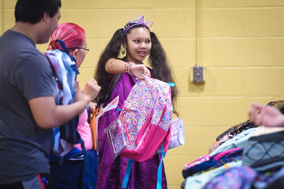 Samalee Vann, 16, is all smiles after making her selection, Wednesday during The Salvation Army’s 10th Annual Backpacks for Kids event. Along with Cenex Zip Trip, more than 5,000 backpacks filled with school supplies are distributed to local schoolchildren. (Dan Pelle / The Spokesman-Review)