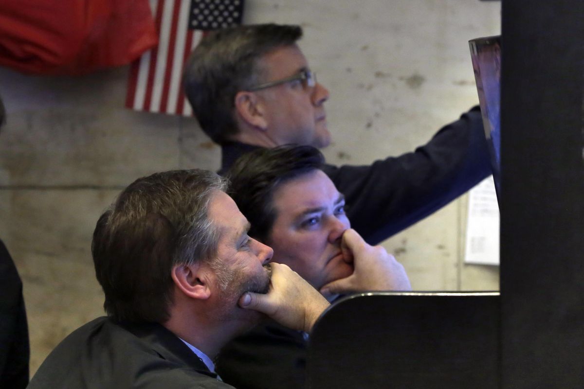 A trio of traders watch their screens in a booth on the floor of the New York Stock Exchange, Monday, Feb. 5, 2018. The Dow Jones industrial average plunged more than 1,100 points Monday as stocks took their worst loss in six and a half years. (Richard Drew / Associated Press)