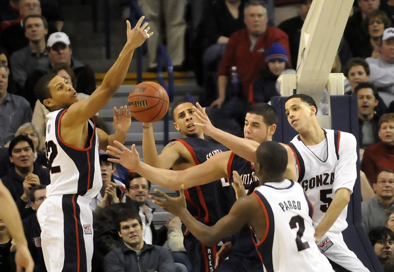 (Left to right) Gonzaga's Steven Gray, Saint Mary's Diamon Simpson and Omar Samhan and GU's Jeremy Pargo and Austin Daye battle for a rebound. (Jesse Tinsley / The Spokesman-Review)