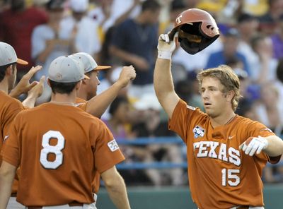 Texas’ Russell Moldenhauer, right, slugged a home run, his fourth of the CWS. (Associated Press / The Spokesman-Review)