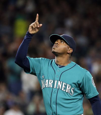 Mariners starter Roenis Elias points skyward after being relieved in eighth inning. (Associated Press)