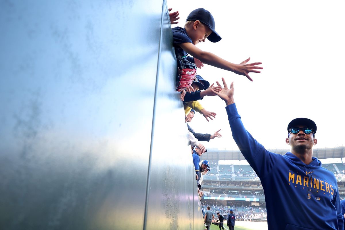 Julio Rodriguez of the Seattle Mariners high-fives fans after the game against the Texas Rangers and their season’s end Sunday at T-Mobile Park in Seattle.  (Getty Images)