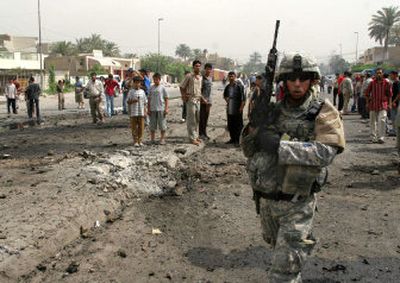 
An U.S. soldier secures the site of a car bomb attack Monday in Baghdad. 
 (Associated Press / The Spokesman-Review)