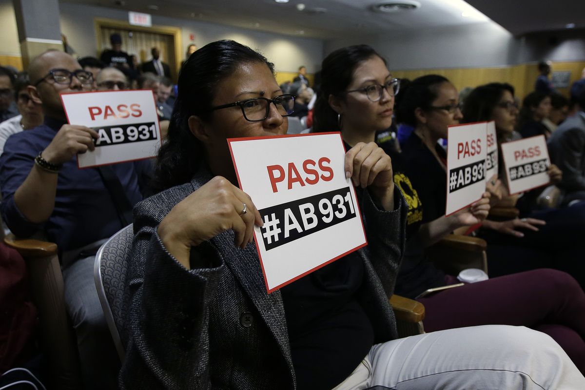 FILE - In this June 19, 2018 file photo, Rosa Cabrera, foreground, joined others in support of a measure to limit police use of deadly force, during a hearing of the Senate Public Safety Committee in Sacramento, Calif. Cases involving police use of force often include questions about the internal records of the officers involved, records that in most cases are off-limits to the press and public. Lawmakers in at least 13 states have considered bills this year to make those records more publicly available.  (Rich Pedroncelli)