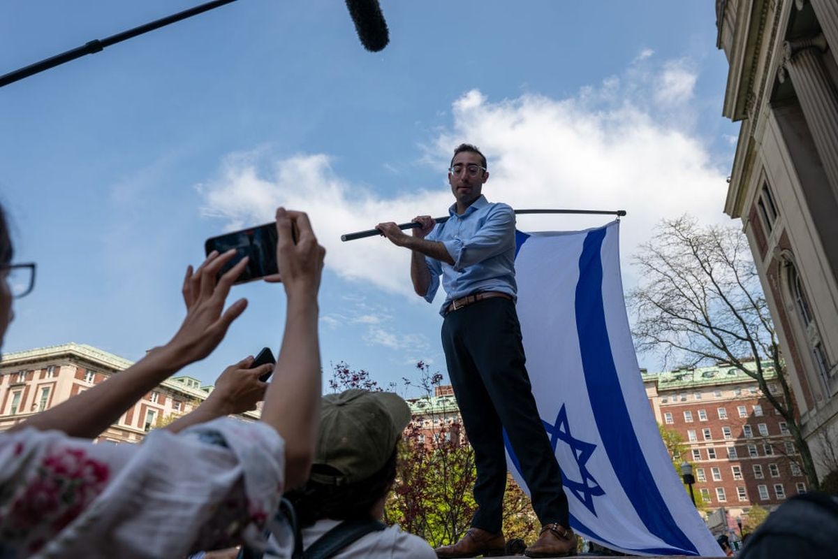 A man waves an Israeli flag as pro-Palestinian supporters continue to demonstrate from a protest encampment on the campus of Columbia University on Monday in New York City. Columbia University issued a notice to the protesters asking them to disband their encampment after negotiations failed to come to a resolution.  (Getty Images)