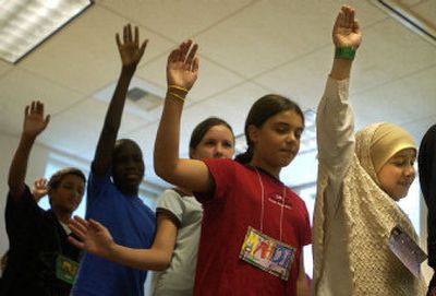 
Raghda Al-Hmeyrat, 11, right, who is from Iraq, and her classmates from around the world take part in a language excercise Tuesday at the language camp at Gonzaga University. 
 (Brian Plonka / The Spokesman-Review)