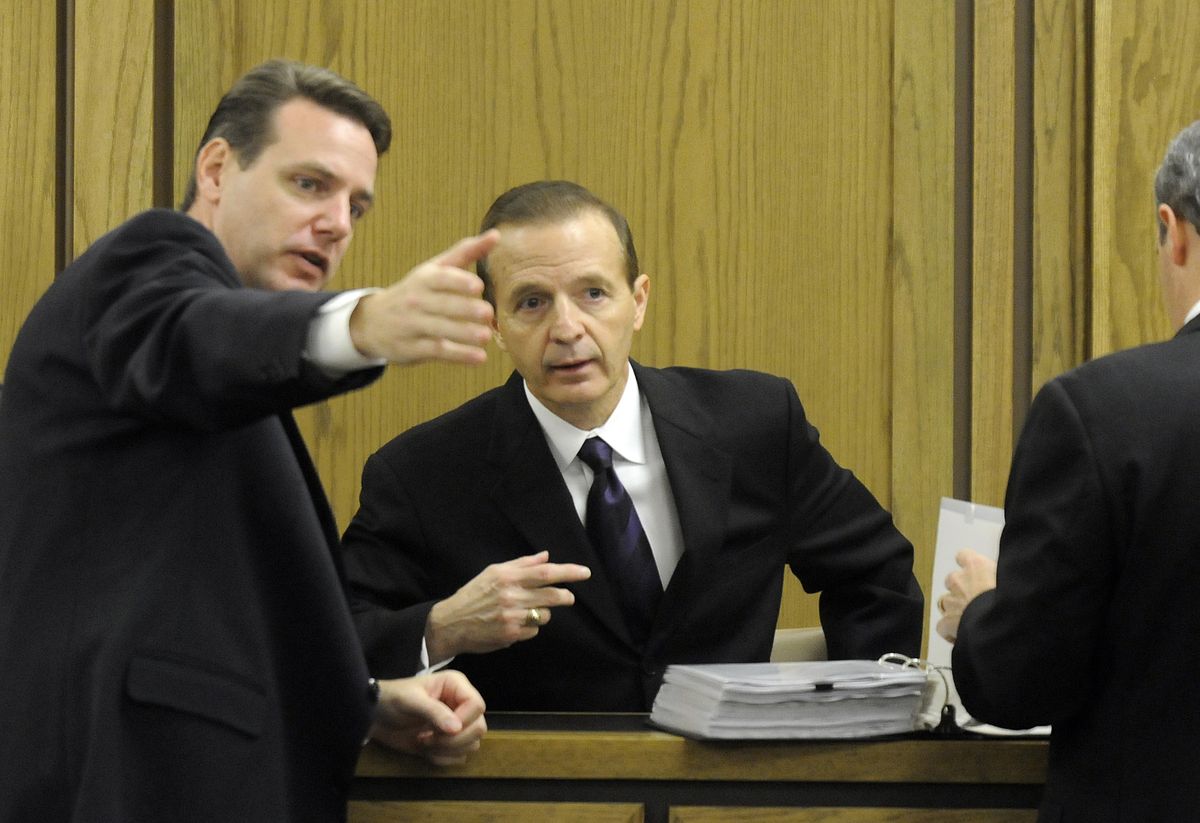 Assistant Attorneys General Todd Bowers, left,  and Malcolm Ross,  talk with witness  Jay Williams, center, during a midmorning break in the civil trial of Kevin Coe  on Monday. Williams testified that he was Coe’s childhood best friend.  (Photos by Dan Pelle / The Spokesman-Review)