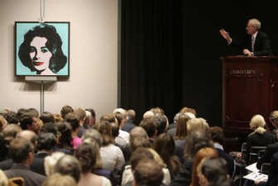 
An auctioneer takes bids on Andy Warhol's 'Liz' during the post-war and contemporary art auction at Christie's in New York in this November file photo. The Warhol was sold for $21 million. Despite turmoil in the financial markets, the art market remains strong due to the weak dollar, expanding world wealth and new buyers from countries previously not associated with the art-collecting community. Associated Press
 (FILE Associated Press / The Spokesman-Review)