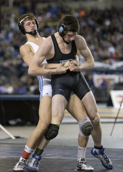 Freeman’s Logan Holt, front, attempts to break free of the grip of his teammate, Nolan Doloughan during the 138-pound championship match at the 1A State Wrestling Tournament Saturday at the Tacoma Dome in Tacoma. Holt won the match 7-1 to take the title. (Patrick Hagerty / Patrick Hagerty)