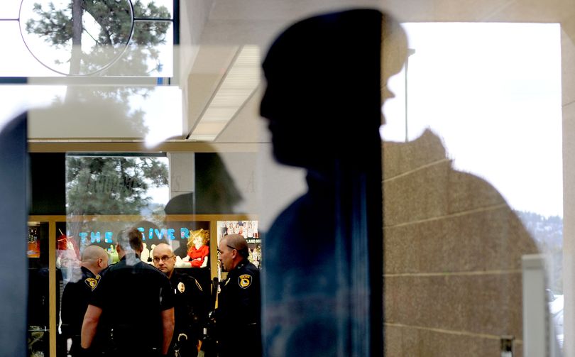 Coeur d'Alene police officers gather in the halls of Woodland Middle School in Coeur d'Alene on Friday, March 11, 2011, after a stabbing incIdent . (Kathy Plonka / The Spokesman Review)