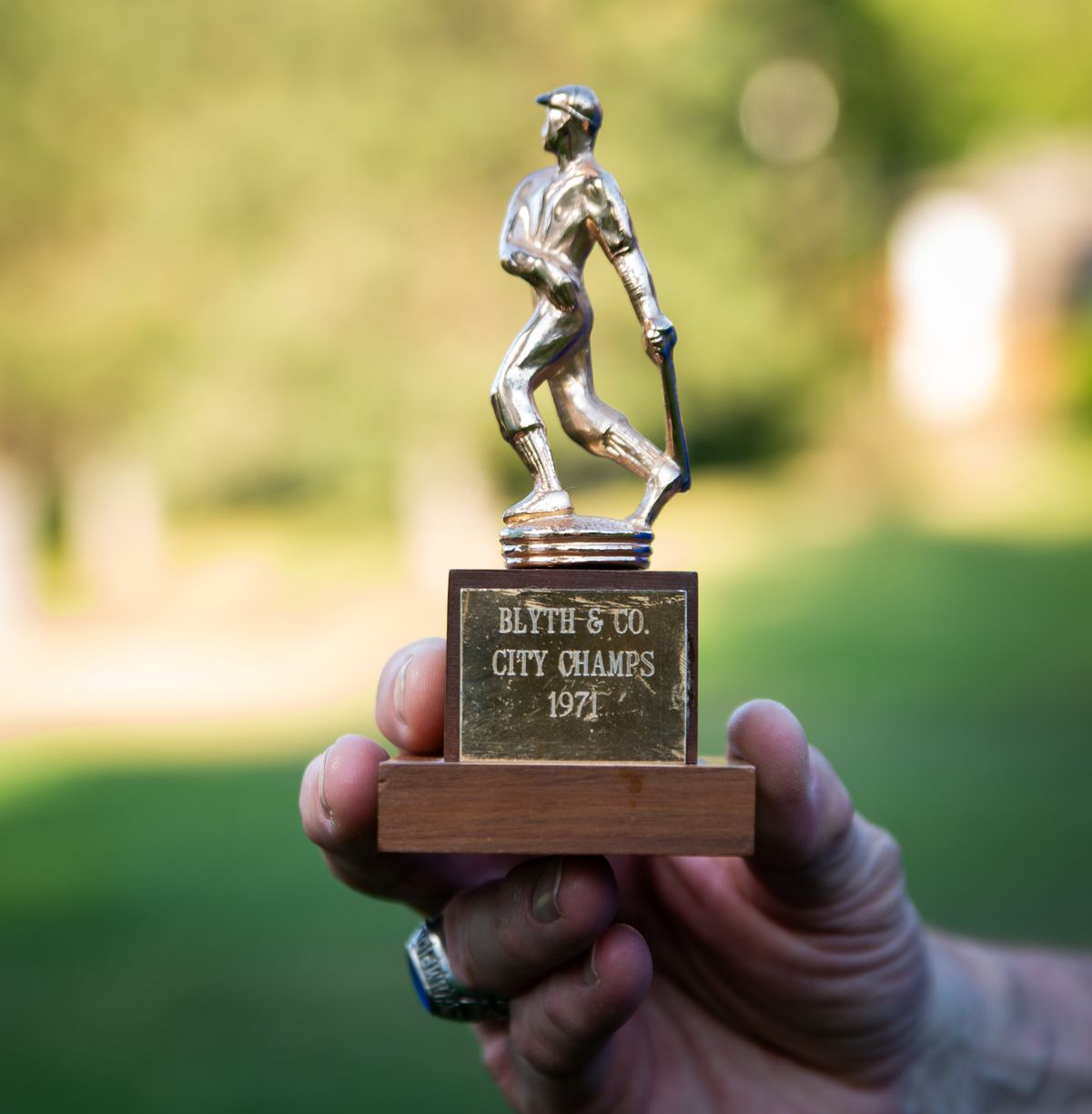 Matt Manning holds up a trophy given to him as part of the 1971 champions Blythe Bullets team at the former home practice playing field, The Resevoir, at 11th and Southeast Boulevard, on July 7, 2021.  (Libby Kamrowski/ THE SPOKESMAN-REVIEW)