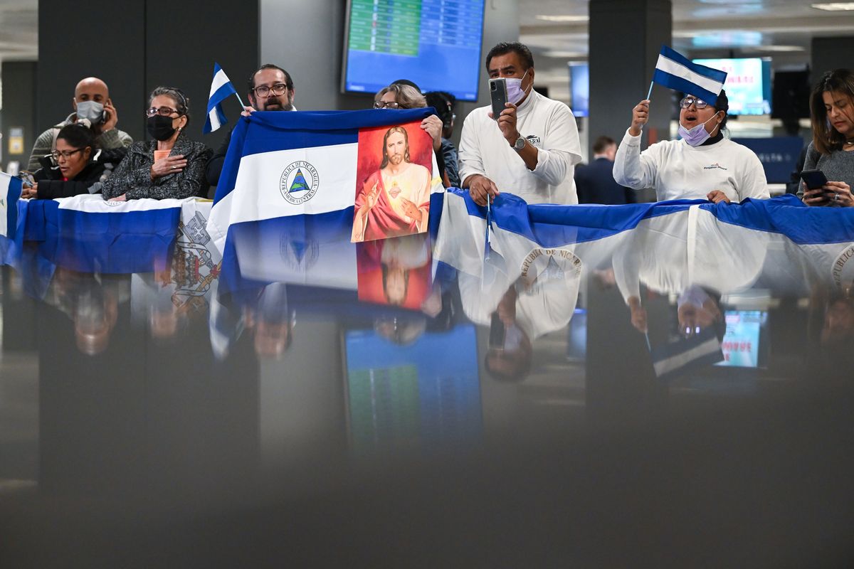 People gather at Dulles International Airport to welcome political prisoners who were released from Nicaragua on Thursday and flown to the United States. MUST CREDIT: Washington Post photo by Matt McClain  (Matt McClain/The Washington Post)