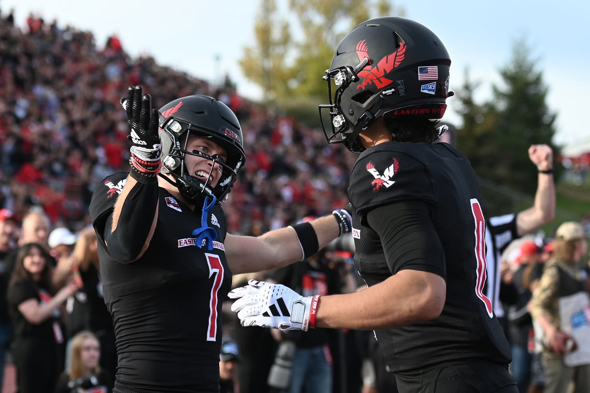 Eastern Washington wide receiver Efton Chism III, left, and quarterback Kekoa Visperas celebrate after a touchdown during the first half of an Oct. 21 Big Sky Conference game against Weber State at Roos Field in Cheney.  (James Snook/The Spokesman-Review)