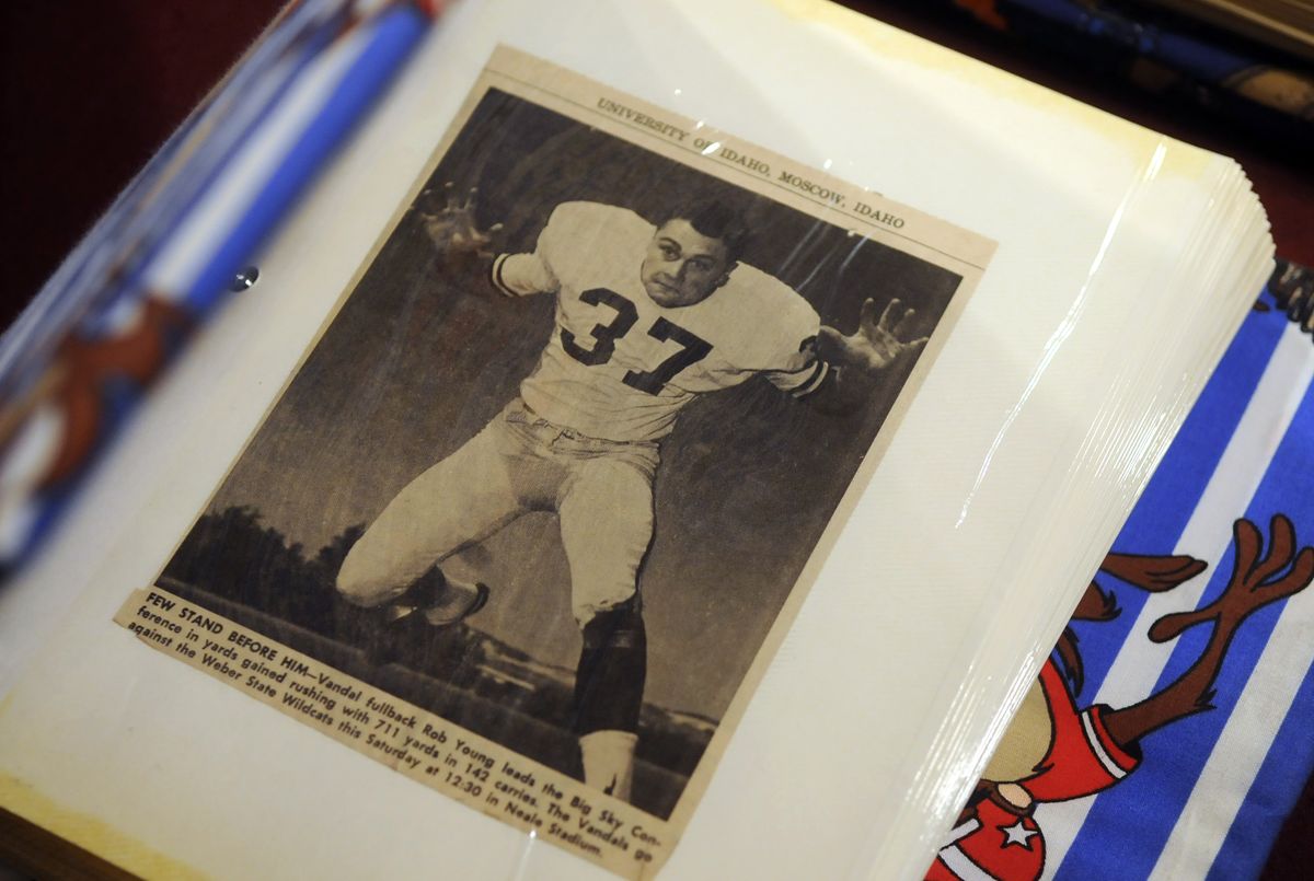 Then: Rob Young has a scrapbook full of pictures and articles from his football playing days at the University of Idaho. (Dan Pelle / The Spokesman-Review)
