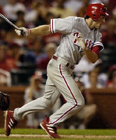 
Philadelphia's Chase Utley follows through on an eighth-inning infield hit to extend his hitting streak to 34 games.
 (Associated Press / The Spokesman-Review)