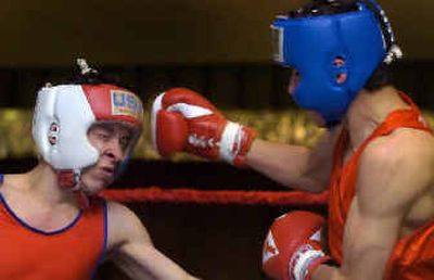 
At the last boxing tournament to be held at the Spokane Eagles Club Saturday, Eric Mafnas, left, with the Eagles Boxing Club takes a punch from Eastmont Boxing Club's Eli Padilia. A new Eagles building won't have room for the club. 
 (Colin Mulvany / The Spokesman-Review)