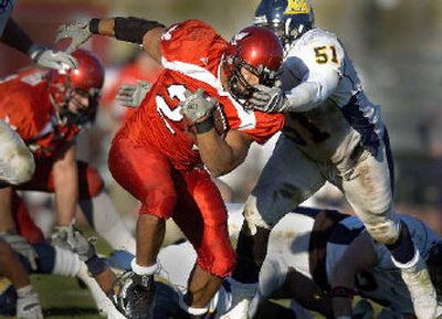 
Northern Arizona lineman DeAndre Johnson grabs the facemask of EWU running back Ryan Cole. 
 (Christopher Anderson / The Spokesman-Review)