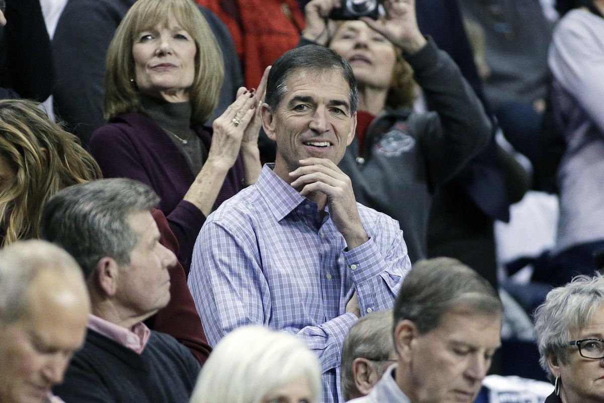 Retired NBA player and Gonzaga alumnus John Stockton, center, looks on before an NCAA college basketball game between Gonzaga and Washington in Spokane on Dec. 7, 2016. Stockton failed in a bid to block the development of 65 acres of wetlands near his Priest Lake residence, according to an Idaho judge’s decision issued in February 2019. (Young Kwak / AP)