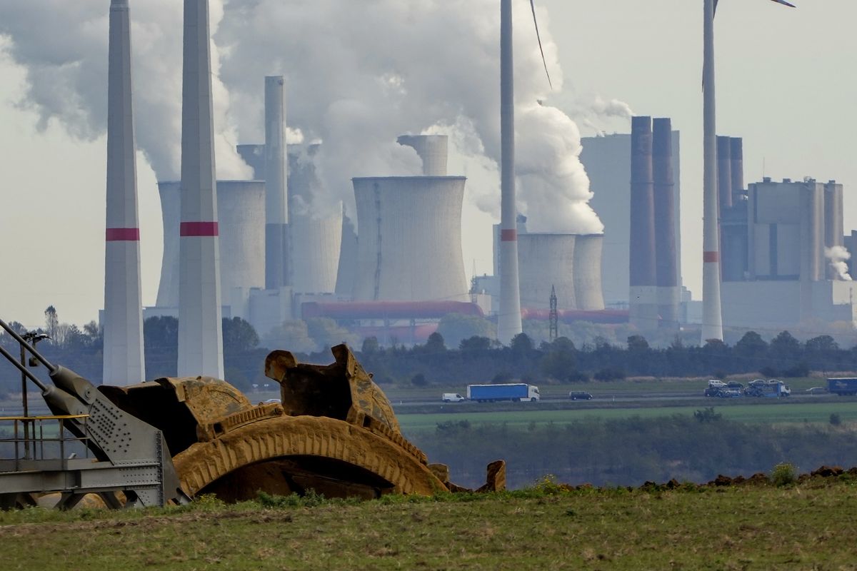 Steam comes out of the chimneys of the coal-fired power station Neurath near the Garzweiler open-cast coal mine Monday in Luetzerath, Germany.  (Michael Probst)