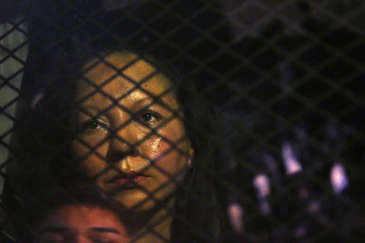 Guadalupe Garcia de Rayos is locked in a van that is stopped in the street by protesters outside the Immigration and Customs Enforcement facility Wednesday, Feb. 8, 2017, in Phoenix. Apparently fearing her deportation, activists blocked the gates surrounding the office near central Phoenix in what the Arizona Republic says was an effort to block several vans and a bus inside from leaving. (Rob Schumacher / AP)