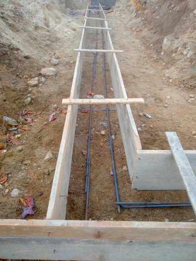 Those gray bumpy rods are ½-inch steel reinforcing bars that will strengthen a garage footing. The contractor now needs to put supports under them so about 3 or 4 inches of concrete separates the rods from the soil. Then it’s time to pour concrete.  (Tim Carter)