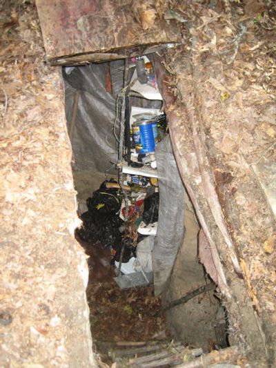 
 A text message sent by a missing 14-year-old girl to her mother's cell phone led police to this hand-dug bunker where the girl was found Saturday in a wooded area near her home. 
 (Associated Press / The Spokesman-Review)