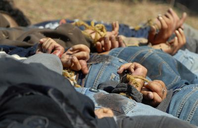 Men with their hands tied behind their backs lie dead in a field near the town of San Ignacio in the state of Sinaloa, Mexico, on Thursday. Police found 13 men who had been fatally shot execution-style.  (Associated Press / The Spokesman-Review)