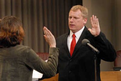 
Michael Allen is sworn in Thursday by City Clerk Terri Pfister as an appointed Spokane City Council member.  
 (Jesse Tinsley / The Spokesman-Review)