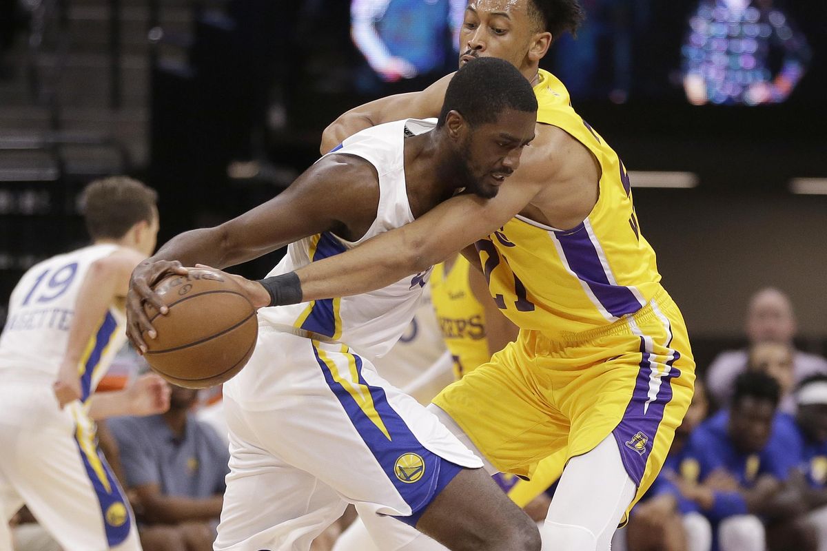 Los Angeles Lakers forward Johnathan Williams, right, tries to steal the ball from Golden State Warriors forward Omari Johnson during the first half of an NBA Summer League game,  July 5 in Sacramento, Calif. (Rich Pedroncelli / AP)