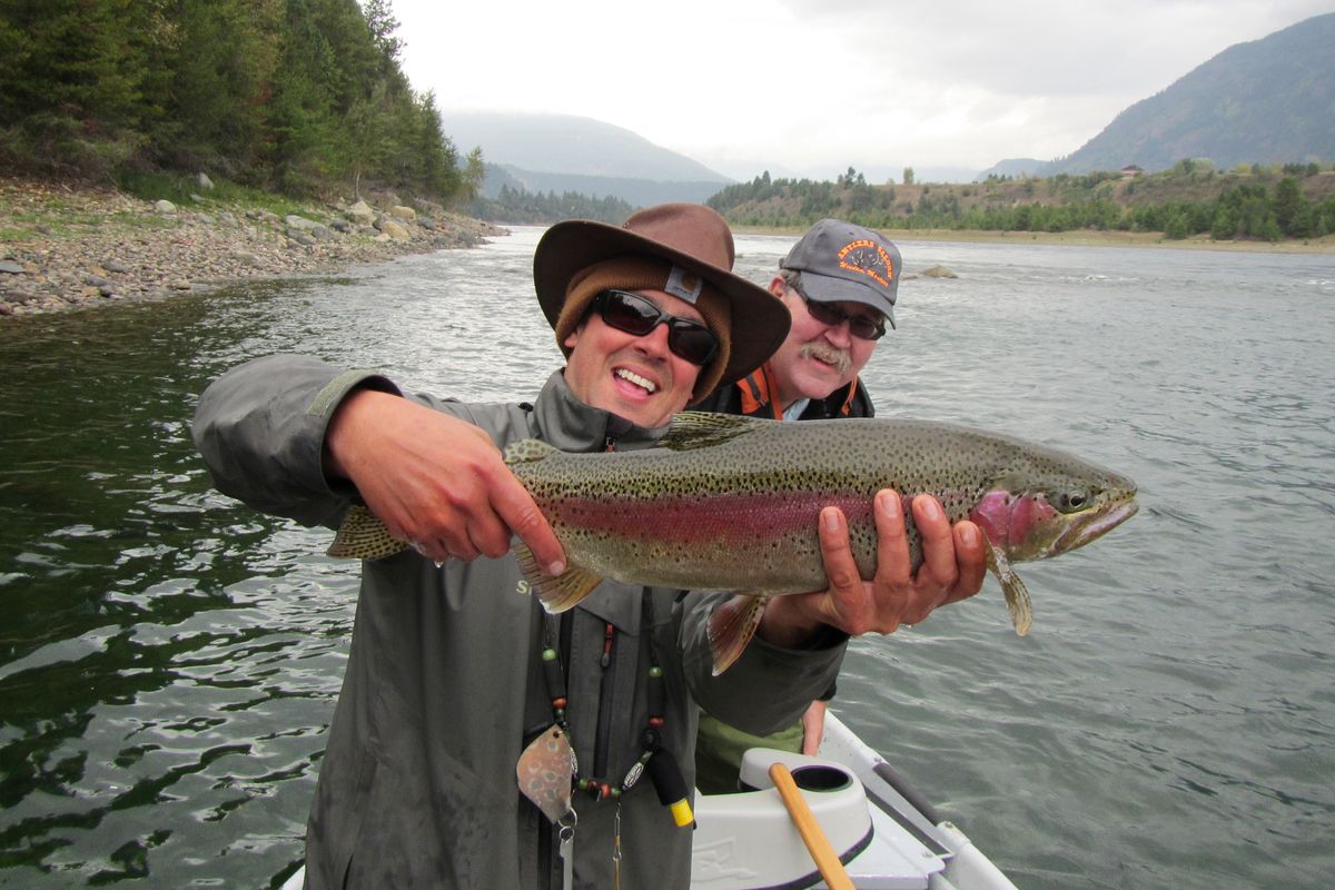 Fly fishers pose with a feisty 23-inch rainbow, "one of four really nice rainbows we caught on the Columbia at Castelgar," on Oct. 1, 2013, with fishing guide John Muir, said Everett Coulter (back) of Spokane. (Hugh Evans)