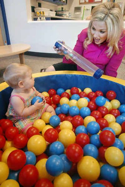 
Kirstie Foster, an employee at General Mills, sees off her daughter, Mia, 8 months, at the company's child-care center in Minneapolis this month. 
 (Associated Press / The Spokesman-Review)