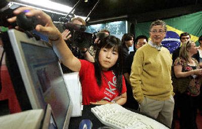 
Microsoft chairman Bill Gates watches Team South Korea member Haeri Lee give a presentation on an exercise and diet software program during a demonstration by Imagine Cup finalists on Wednesday.  
 (Associated Press / The Spokesman-Review)