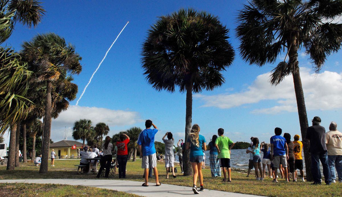 Crowds of people watch from Kelly Park on Merritt Island, Fla., to see the launch of the Mars rover on Saturday. (Associated Press)