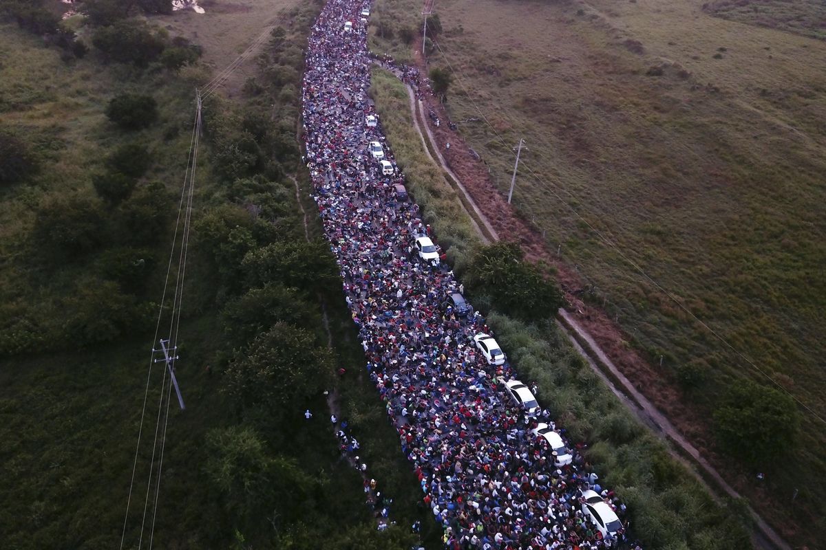 Members of a US-bound migrant caravan cross a bridge between the Mexican states of Chiapas and Oaxaca after federal police briefly blocked them outside the town of Arriaga, on Saturday, Oct. 27, 2018. Hundreds of Mexican federal officers carrying plastic shields had blocked the caravan from advancing toward the United States, after several thousand of the migrants turned down the chance to apply for refugee status and obtain a Mexican offer of benefits. (Rodrigo Abd / AP)