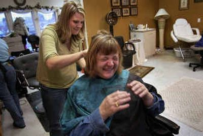 
Stephanie Zoldak giggles in anticipation of seeing her newly blonde hair while stylist Sara Chase works on the final touches in the Nichole & Co. Salon in Post Falls on Tuesday. Post Falls Middle School students raised more than $800 for Union Gospel Mission in order to see their teacher's hair color change. 
 (Liz Kishimoto / The Spokesman-Review)