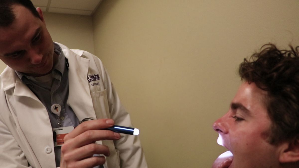Medical student Seth Dotson examines a patient as part of his medical education. (Courtesy University of Washington School of Medicine)