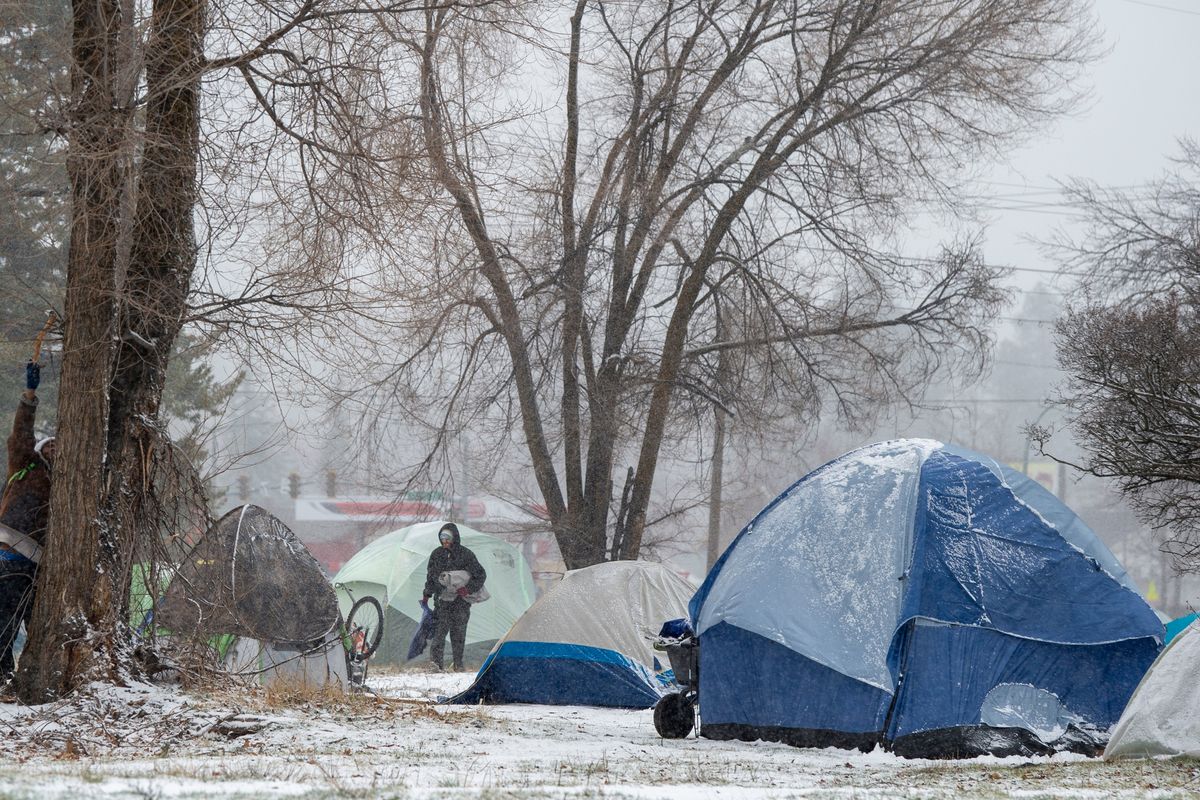 A homeless tent camp popped up on an empty lot in east Spokane on Dec. 16, after homeless protesters at Spokane City Hall were warned to vacate the area by that morning.  (Jesse Tinsley/The Spokesman-Review)