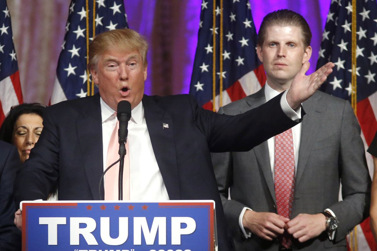 FILE - In this Tuesday, March 15, 2016, file photo, Republican presidential candidate Donald Trump speaks to supporters at his primary election night event at his Mar-a-Lago Club in Palm Beach, Fla. At right is his son Eric Trump. Hits to President Donald Trump’s business empire since the deadly riots at the U.S. Capitol are part of a liberal “cancel culture,” his son Eric told The Associated Press on Tuesday, Jan. 12, 2021, saying his father will leave the presidency with a powerful brand backed by millions of voters who will follow him “to the ends of the Earth.”  (Gerald Herbert)