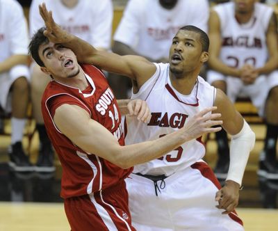 After shooting a jumper, Eastern's Laron Griffin arm comes down on South Dakota's Ricardo Andreotti's face in the second half on Reese Court in Cheney Tuesday night. (Colin Mulvany / The Spokesman-Review)