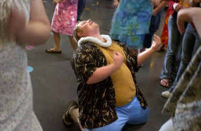 
University High School student Jim Cox plays air guitar on his knees as the song 