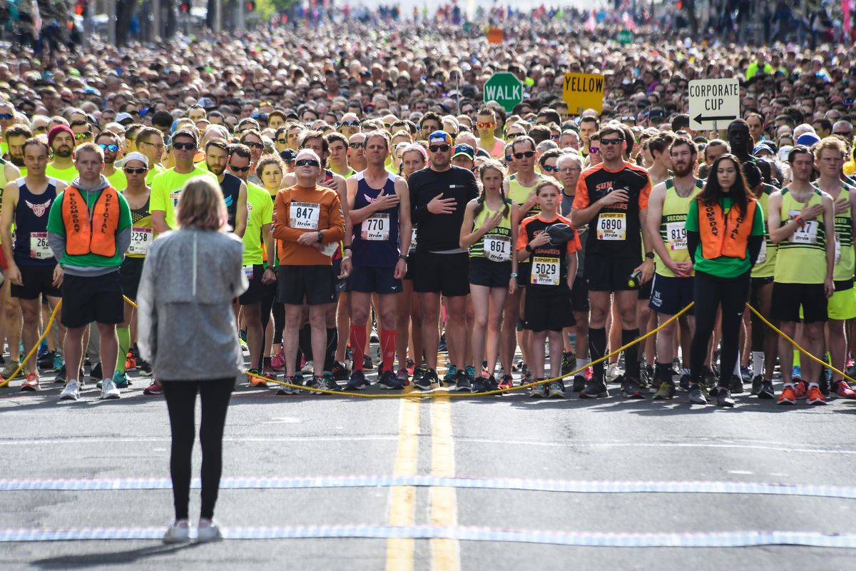 Bloomsday participates pause for the National Anthem before the start of the race, Sunday, May 5, 2019. (Dan Pelle / The Spokesman-Review)