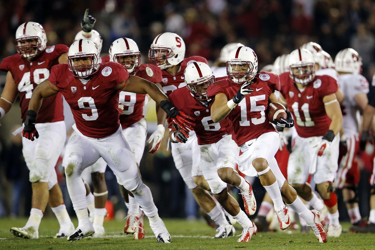 Stanford cornerback Usua Amanam (15) celebrates with teammates after making an interception that sealed the Cardinal’s triumph. (Associated Press)