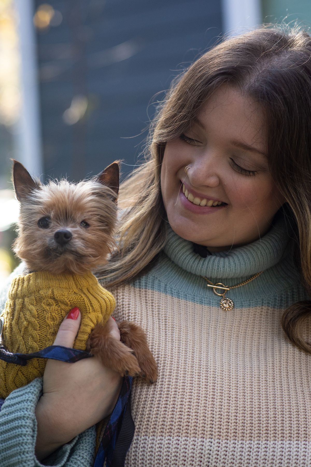 Kursten Hedgis holds her dog Bitsy in front of her home Dec. 9, 2020, in Decatur, Ga. Bitsy is 14 and has been with her six years after a life as a breeder in a puppy mill. He is blind in one eye and suffers periodic infections and incontinence. Trips to the veterinarian have been “really scary” because of the masks and reduced contacts. However, Hedgis and other pet owners say they have become more than companions in recent months, that they provide valuable emotional support to their humans.  (Ron Harris)
